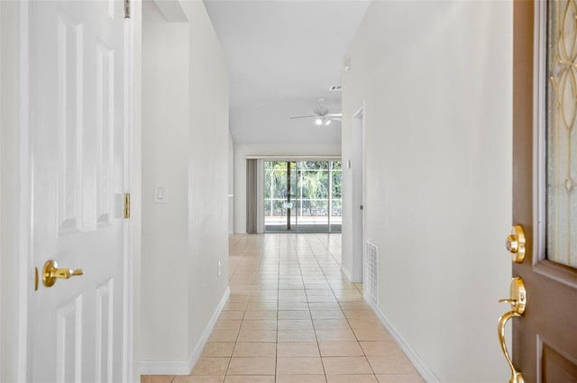 corridor featuring light tile patterned flooring