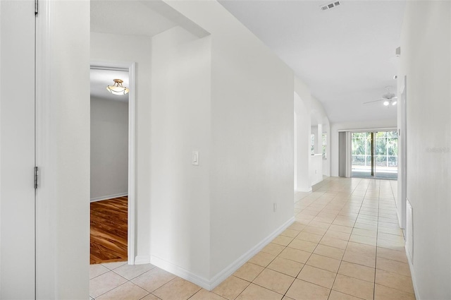 hall featuring light tile patterned floors