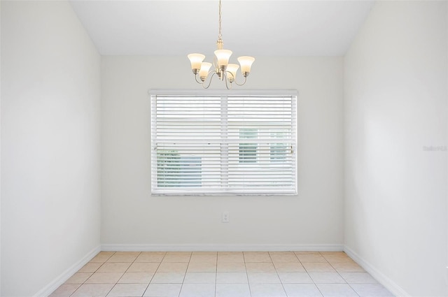 unfurnished room featuring a chandelier and light tile patterned floors