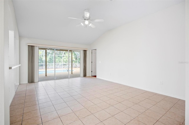 spare room with ceiling fan, light tile patterned flooring, and lofted ceiling