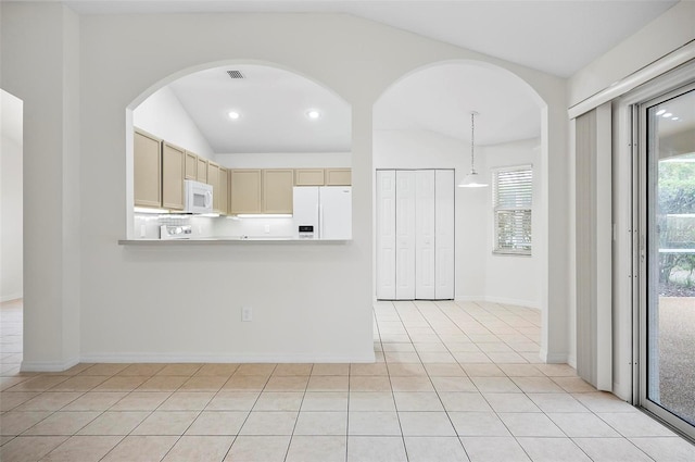 kitchen featuring pendant lighting, white appliances, light tile patterned floors, and vaulted ceiling