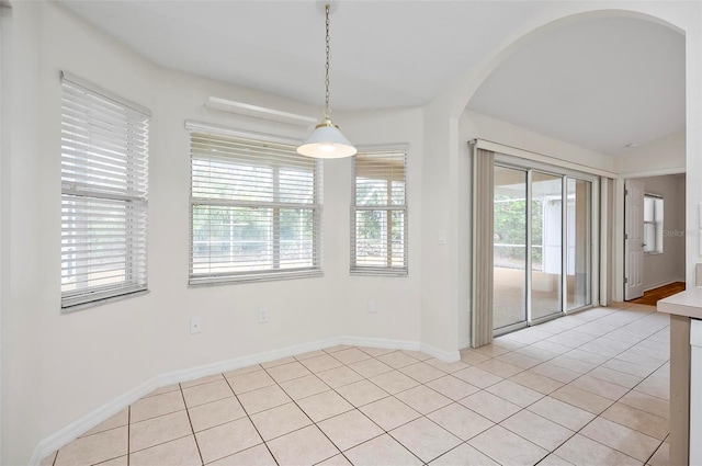 unfurnished dining area featuring light tile patterned floors