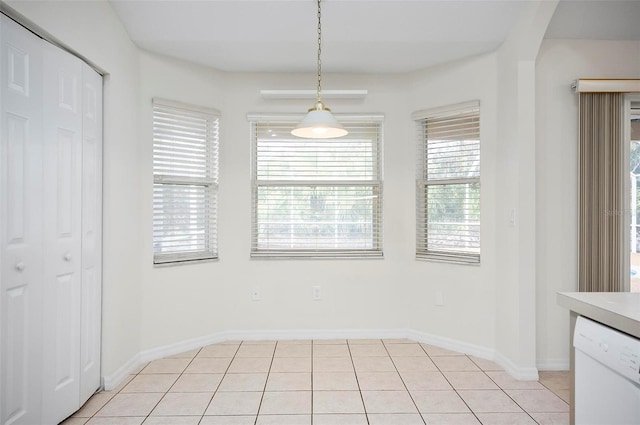 unfurnished dining area with light tile patterned flooring