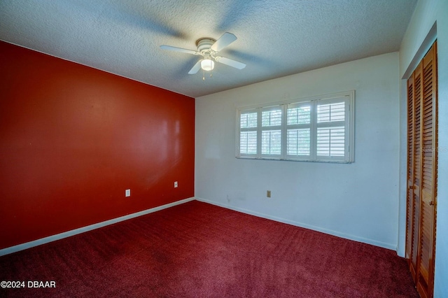 unfurnished bedroom with carpet flooring, ceiling fan, a textured ceiling, and a closet