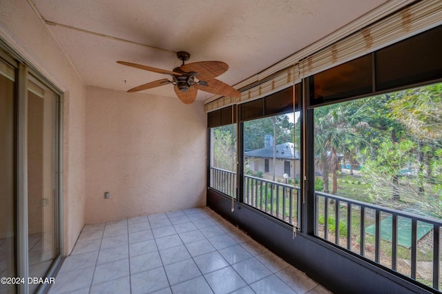 unfurnished sunroom with ceiling fan