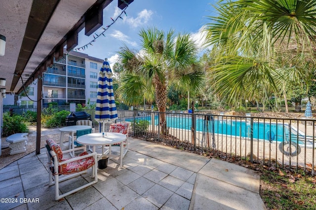 view of patio / terrace featuring a community pool