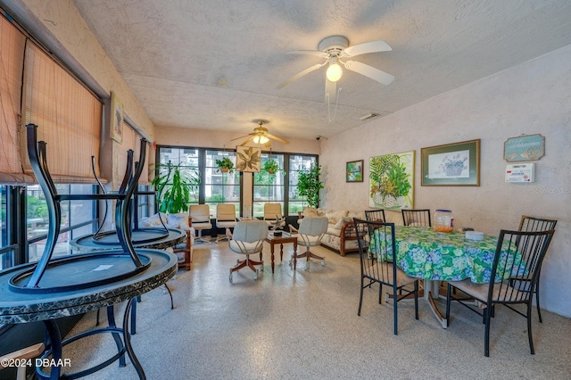 dining room featuring ceiling fan and a textured ceiling