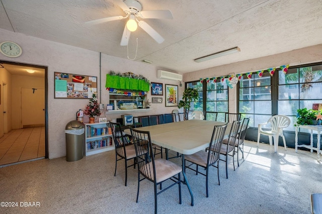 dining room featuring a textured ceiling, an AC wall unit, and ceiling fan