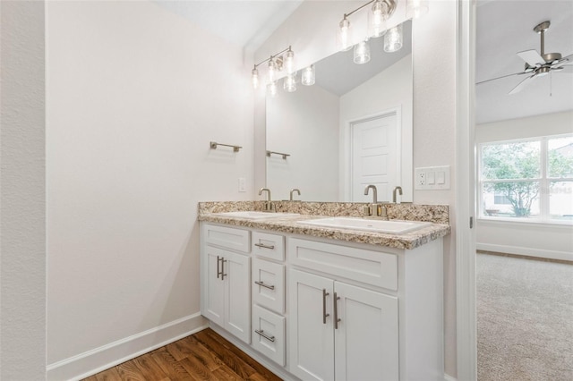bathroom with double vanity, a sink, ceiling fan, and lofted ceiling