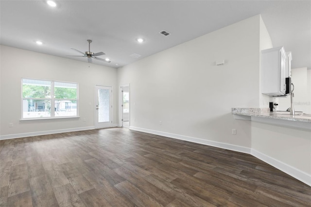 25 Port Echo Ln, Palm Coast, FL 32164 - unfurnished living room featuring dark wood-style floors, a ceiling fan, and recessed lighting