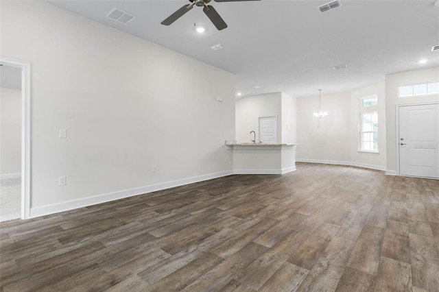 25 Port Echo Ln, Palm Coast, FL 32164 - unfurnished living room with dark wood-style flooring, a chandelier, ceiling fan, and recessed lighting