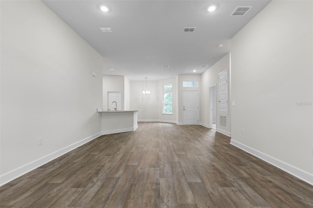25 Port Echo Ln, Palm Coast, FL 32164 - unfurnished living room with dark wood-type flooring, recessed lighting, and a chandelier