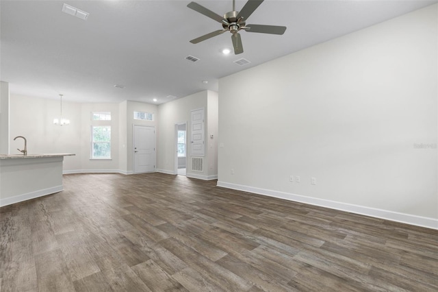 25 Port Echo Ln, Palm Coast, FL 32164 - unfurnished living room with dark wood-style floors, a ceiling fan, a chandelier, and recessed lighting
