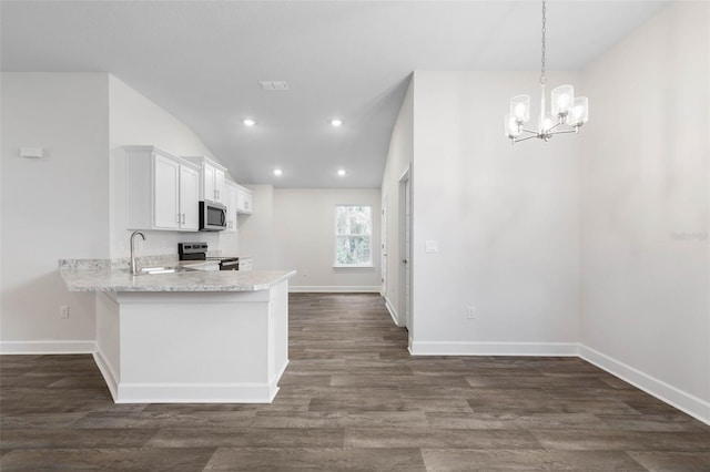 25 Port Echo Ln, Palm Coast, FL 32164 - kitchen with stainless steel appliances, white cabinets, a peninsula, dark wood-style flooring, and a chandelier
