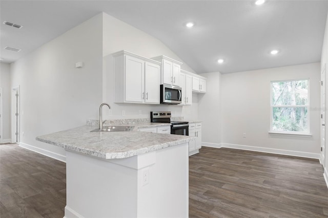 25 Port Echo Ln, Palm Coast, FL 32164 - kitchen featuring appliances with stainless steel finishes, dark wood-style floors, lofted ceiling, white cabinetry, and recessed lighting