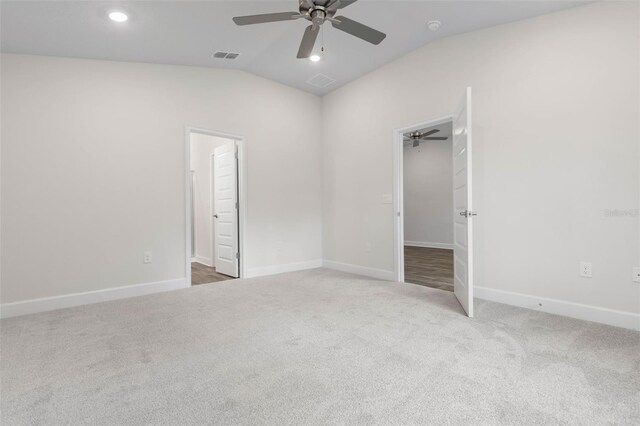 25 Port Echo Ln, Palm Coast, FL 32164 - unfurnished bedroom with vaulted ceiling, carpet flooring, ceiling fan, recessed lighting, and a walk in closet