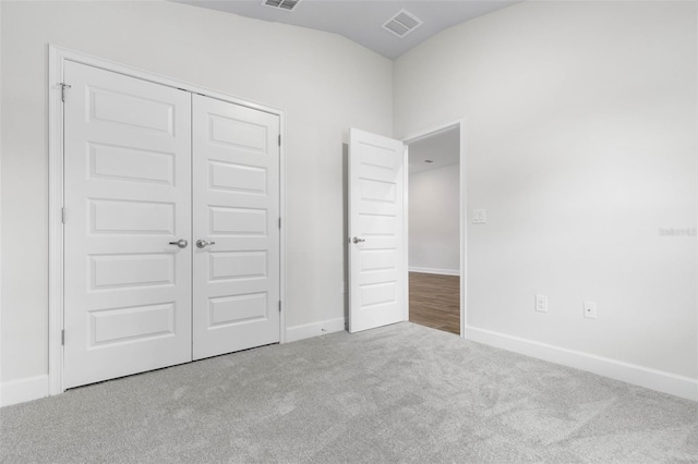 25 Port Echo Ln, Palm Coast, FL 32164 - unfurnished bedroom with carpet floors, lofted ceiling, and a closet