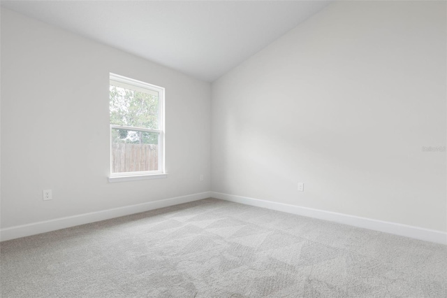 25 Port Echo Ln, Palm Coast, FL 32164 - unfurnished room with lofted ceiling and light carpet