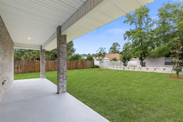 25 Port Echo Ln, Palm Coast, FL 32164 - fenced backyard featuring a patio area