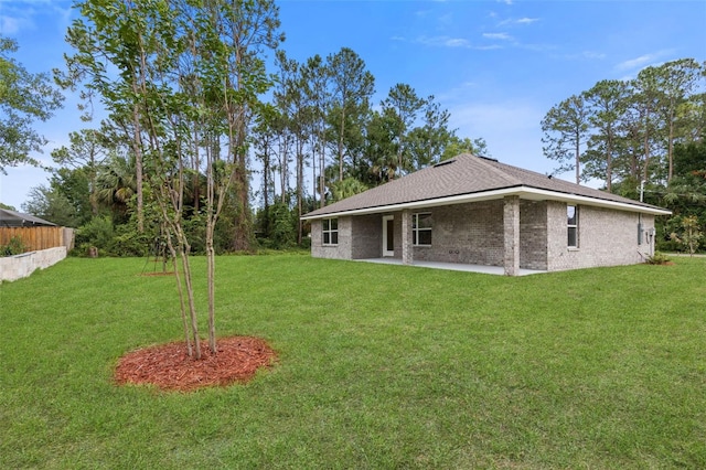 25 Port Echo Ln, Palm Coast, FL 32164 - back of house featuring a yard, a patio area, and brick siding