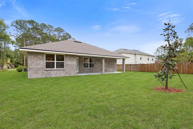 25 Port Echo Ln, Palm Coast, FL 32164 - rear view of property featuring a patio, roof with shingles, and brick siding