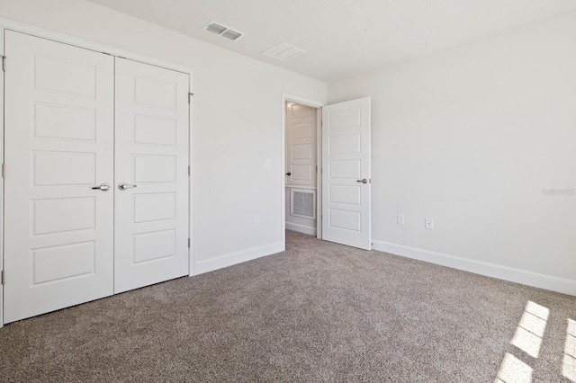 unfurnished bedroom featuring a closet and carpet flooring