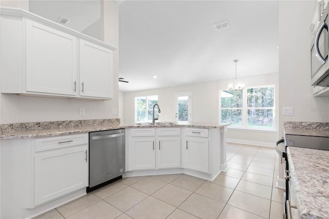 kitchen featuring sink, hanging light fixtures, kitchen peninsula, stainless steel appliances, and white cabinets