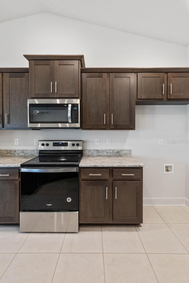 kitchen with dark brown cabinetry, lofted ceiling, and appliances with stainless steel finishes