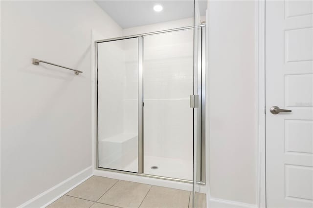 bathroom featuring tile patterned flooring and an enclosed shower