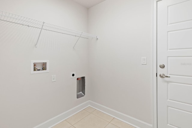 washroom with electric dryer hookup, washer hookup, and light tile patterned floors