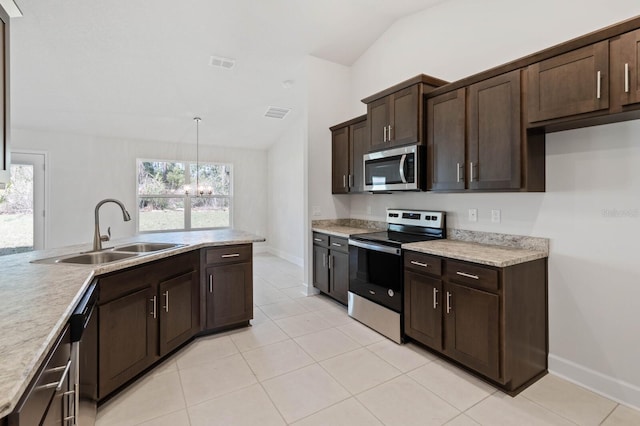 kitchen featuring vaulted ceiling, decorative light fixtures, sink, dark brown cabinetry, and stainless steel appliances