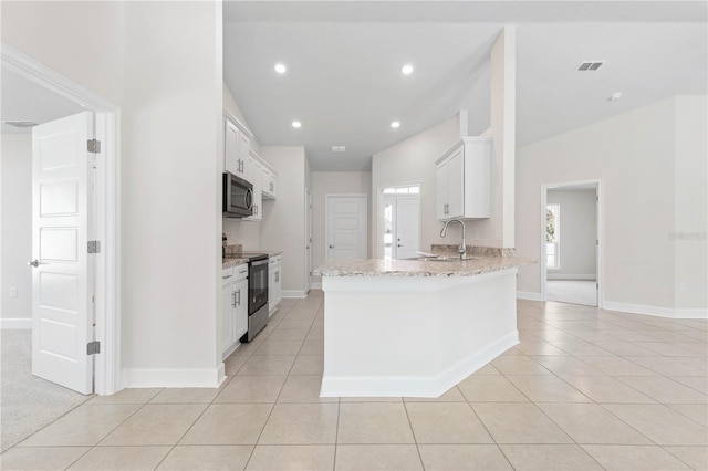 kitchen featuring stainless steel appliances, white cabinetry, sink, and light tile patterned floors