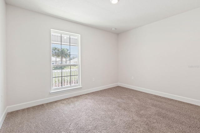 unfurnished room featuring plenty of natural light and carpet flooring