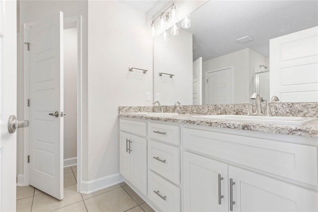 bathroom with vanity, a shower with door, and tile patterned floors