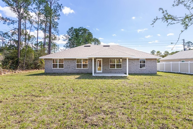 back of property with a lawn and a patio area