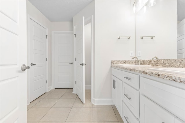 bathroom with tile patterned flooring and vanity