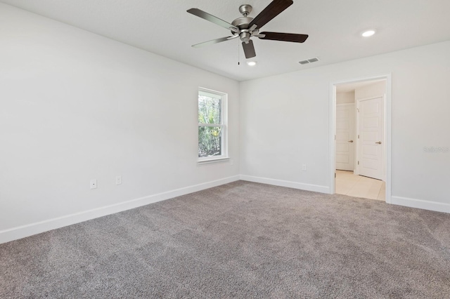 carpeted empty room featuring ceiling fan