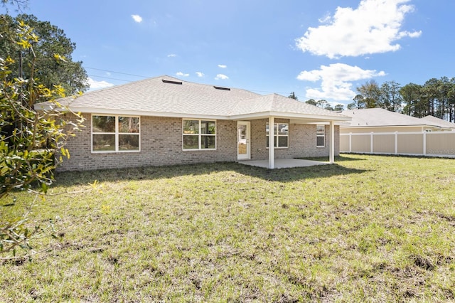 back of property featuring a yard and a patio area