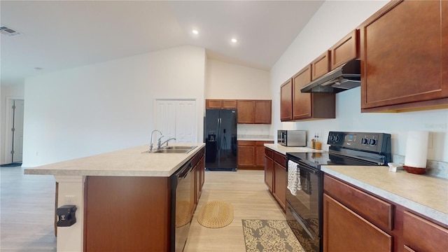 kitchen featuring ventilation hood, sink, black appliances, light hardwood / wood-style floors, and an island with sink