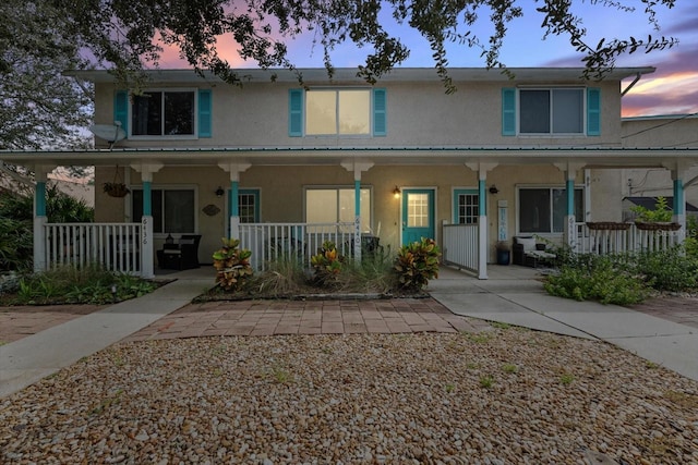 view of property featuring covered porch