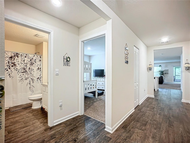 corridor with dark wood-type flooring