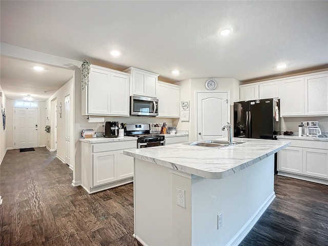 kitchen with white cabinets, appliances with stainless steel finishes, and sink