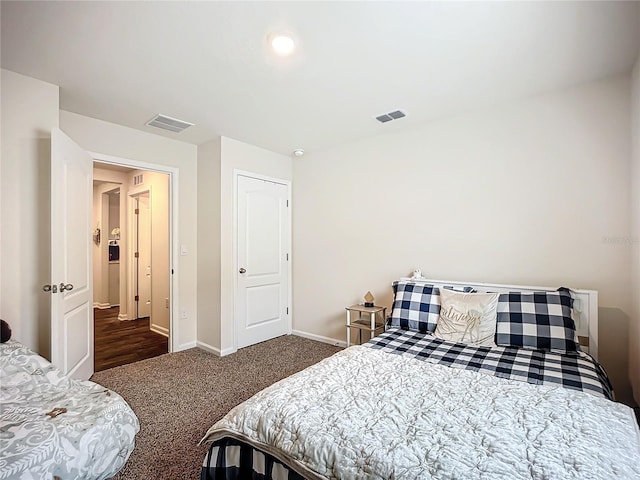 bedroom with dark colored carpet