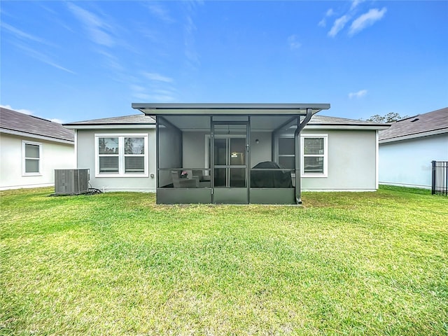 back of house featuring a lawn and central AC