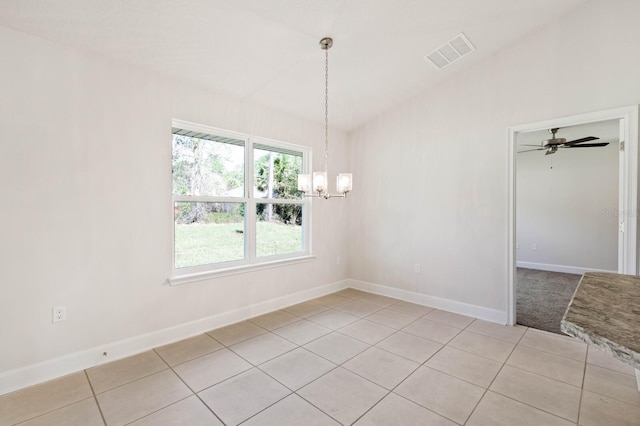 unfurnished dining area featuring light tile patterned floors and a notable chandelier