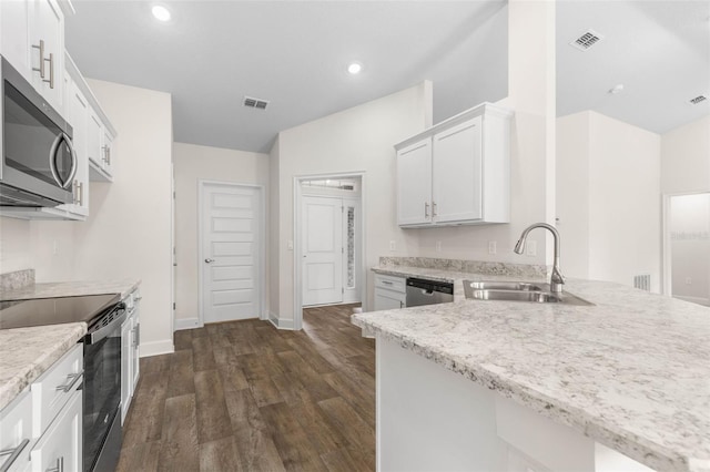 39 Zaun Trl, Palm Coast, FL 32164 - kitchen with a sink, appliances with stainless steel finishes, baseboards, dark wood-style floors, and white cabinets