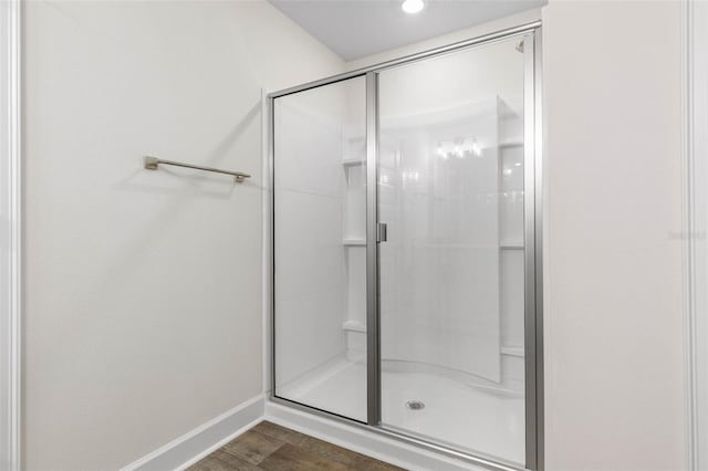39 Zaun Trl, Palm Coast, FL 32164 - bathroom featuring a shower stall, baseboards, and wood finished floors
