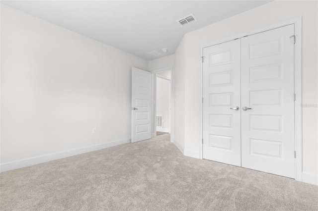 39 Zaun Trl, Palm Coast, FL 32164 - unfurnished bedroom featuring carpet, a closet, and baseboards