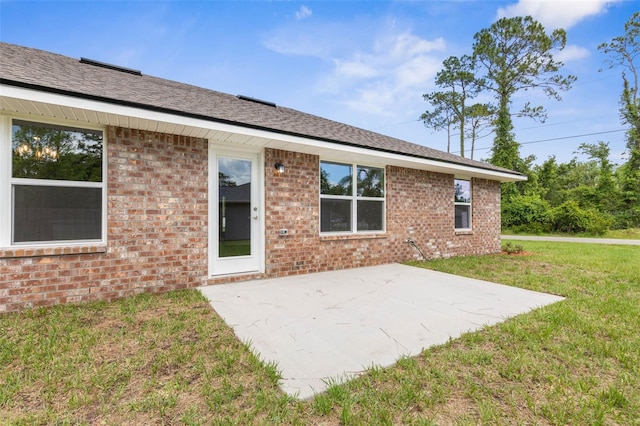 39 Zaun Trl, Palm Coast, FL 32164 - rear view of property with a patio area, a lawn, and brick siding