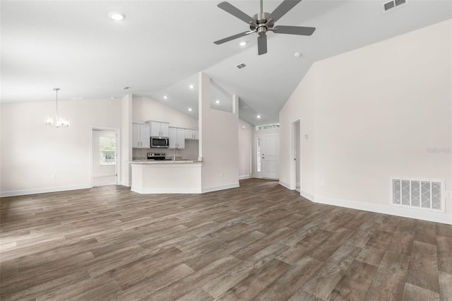 39 Zaun Trl, Palm Coast, FL 32164 - unfurnished living room with a chandelier, a ceiling fan, wood finished floors, high vaulted ceiling, and recessed lighting